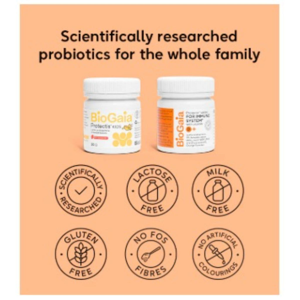 Two BioGaia probiotic supplement bottles displayed on a peach-colored background with promotional text and six circular badges highlighting product features such as scientifically researched, lactose free, milk free, gluten free, no FOS fibres, and no artificial colourings.