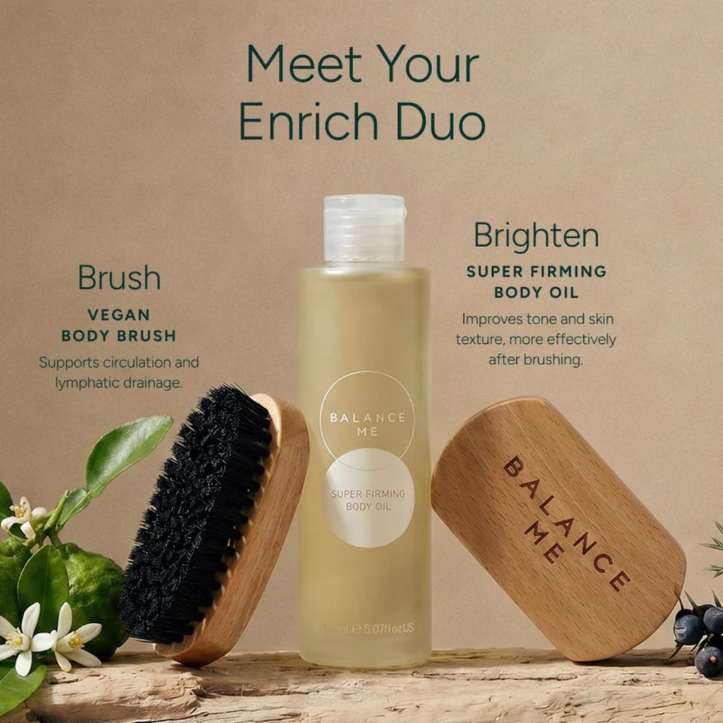 Balance Me Brush and Brighten duo featuring vegan body brushes and Super Firming Body Oil on a rustic wooden surface with botanicals