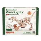 The retail packaging box for the Prehistoric Planet Velociraptor LDO1 'Hunter of the Jungle' wooden model kit by ROKR. The box features a white background with green borders, displaying a detailed illustration of the assembled wooden dinosaur skeleton model with a small theropod carrying a baby dinosaur.