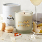 Cupidly You Light Up My Life luxury scented candle in a sleek glass jar with a warm, glowing flame.