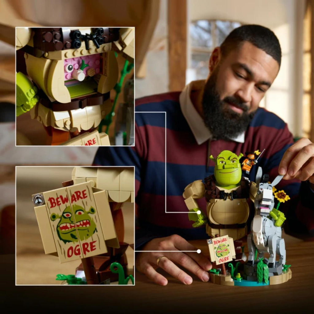 Man playing with a LEGO Shrek set, highlighting details like Ogre and 'Beware of Ogre' sign.
