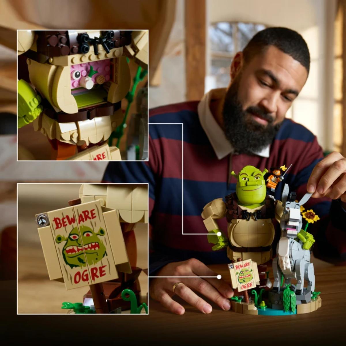 Man playing with a LEGO Shrek set, highlighting details like Ogre and 'Beware of Ogre' sign.