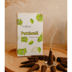 Patchouli incense cones arranged on a surface, releasing warm earthy fragrance.